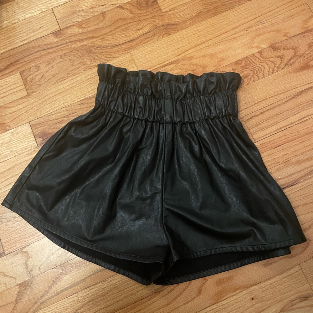 Black leather shorts, cinched at the waist